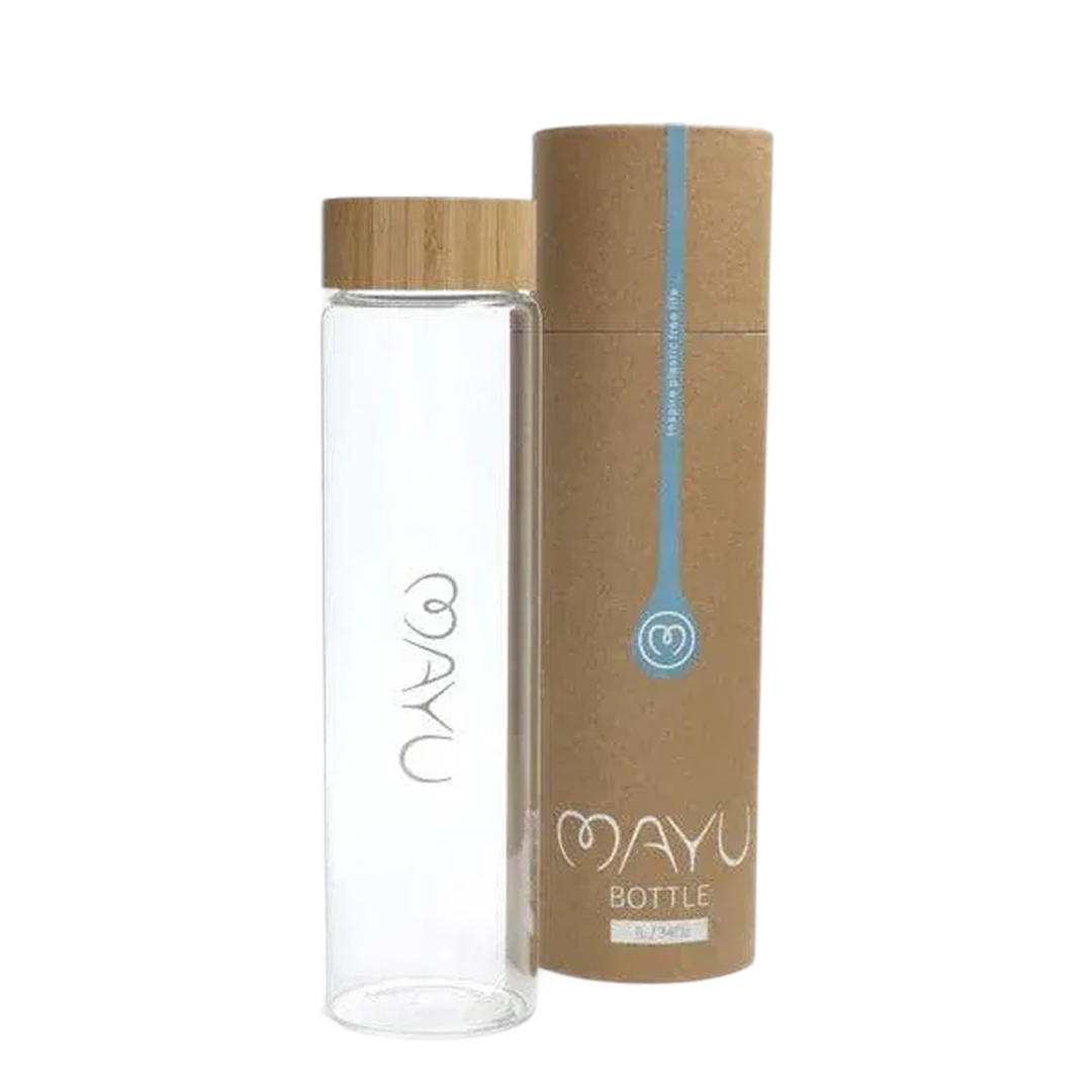 A Pure Glass Bottle from Mayu Water, made of clear BPA-free glass with a wooden lid, stands next to its cylindrical brown cardboard packaging—both branded with Mayu Water—on a plain white background.