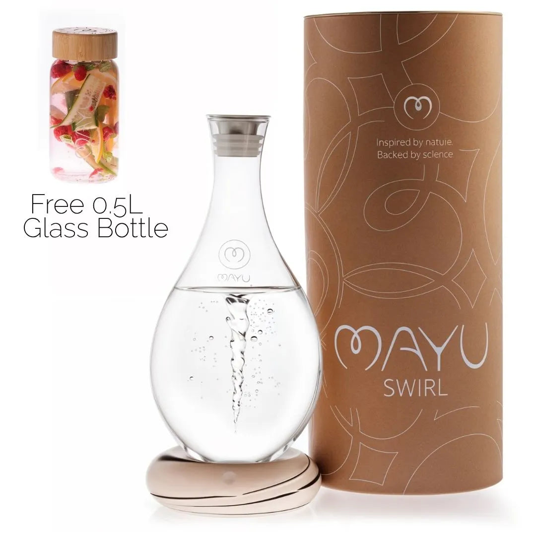 The MAYU Swirl Carafe by Mayu Water creates a swirling vortex, shown beside its beige cylindrical packaging. Inset displays a free 0.5L handblown borosilicate glass bottle with fruit-infused water and a wooden lid.