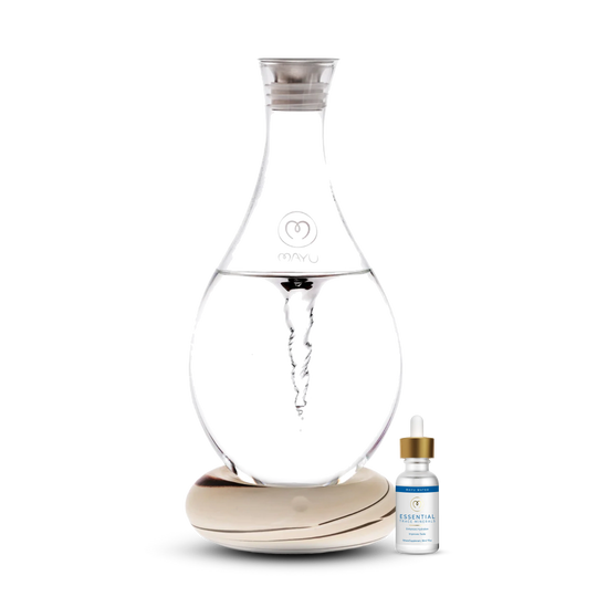 The Mayu Water Basic Starter Kit features a clear, teardrop-shaped Swirl Structured Water Carafe on a round wooden base, with a Trace Mineral Drops bottle beside it—all set against a white background.