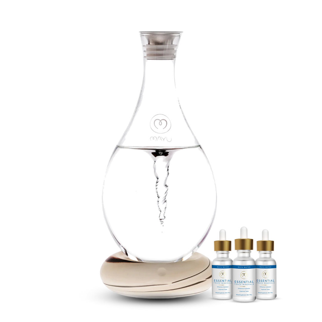 The Best Selling Starter Kit by Mayu Water features a Structured Water Carafe with a visible vortex on a round wooden base, plus three Essential Minerals bottles filled with Trace Mineral Drops for complete hydration.