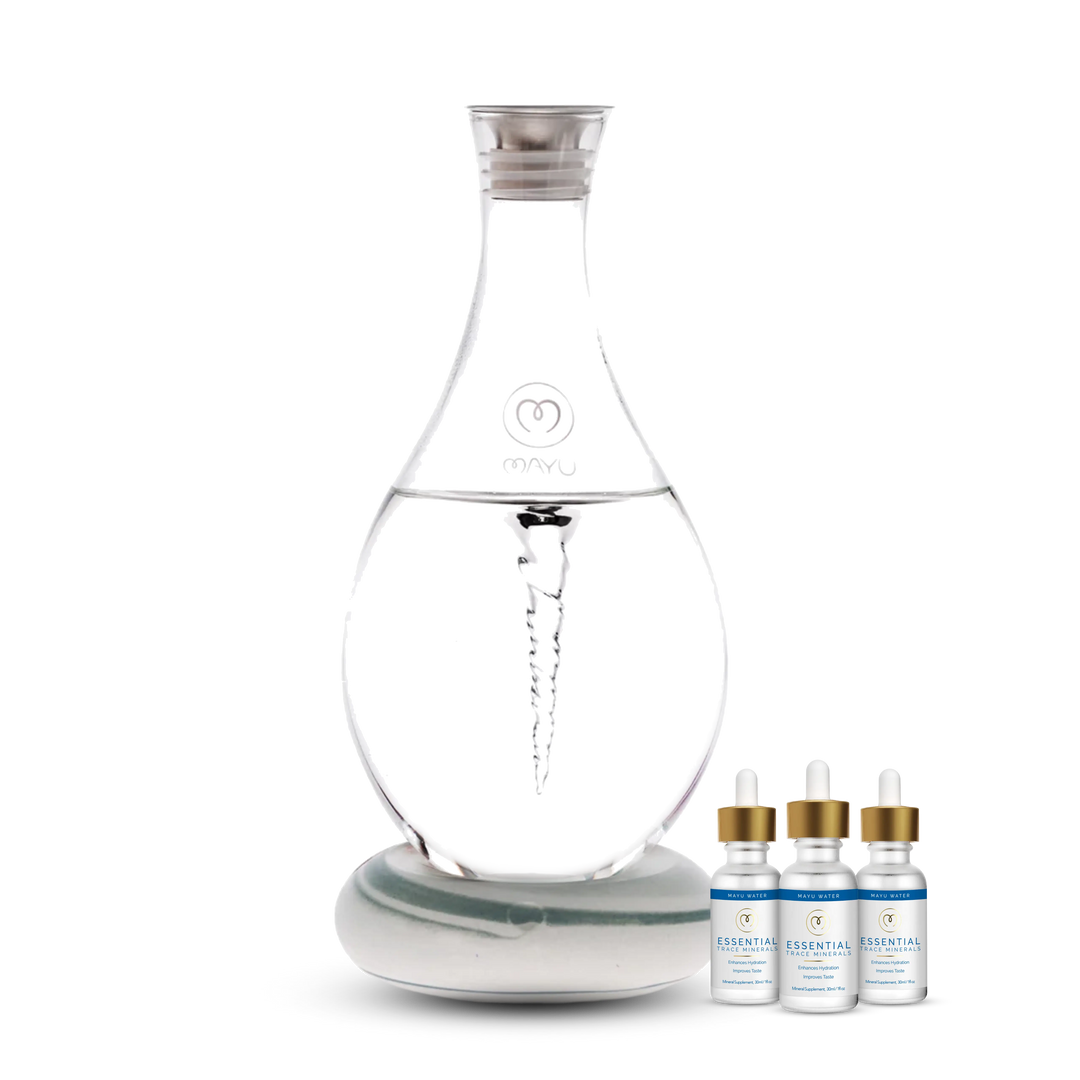 The Best Selling Starter Kit by Mayu Water features a clear Structured Water Carafe with a vortex on a base, alongside three Essential Minerals dropper bottles—an innovative hydration solution for enhanced wellness.