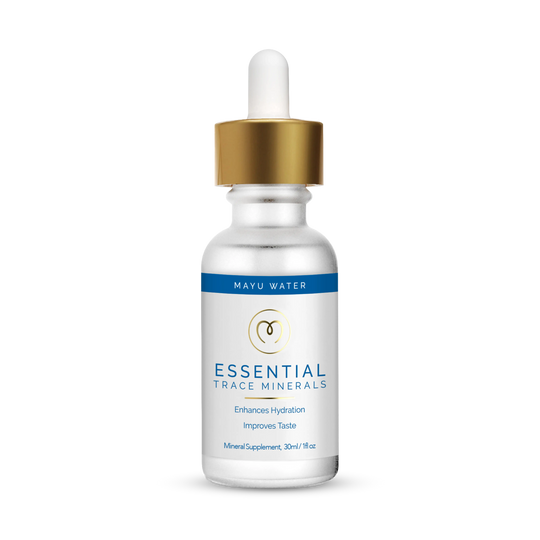 A small frosted glass dropper bottle labeled Trace Mineral Drops by Mayu Water, featuring a gold and white dropper cap with blue accents, stands upright on a plain white background.