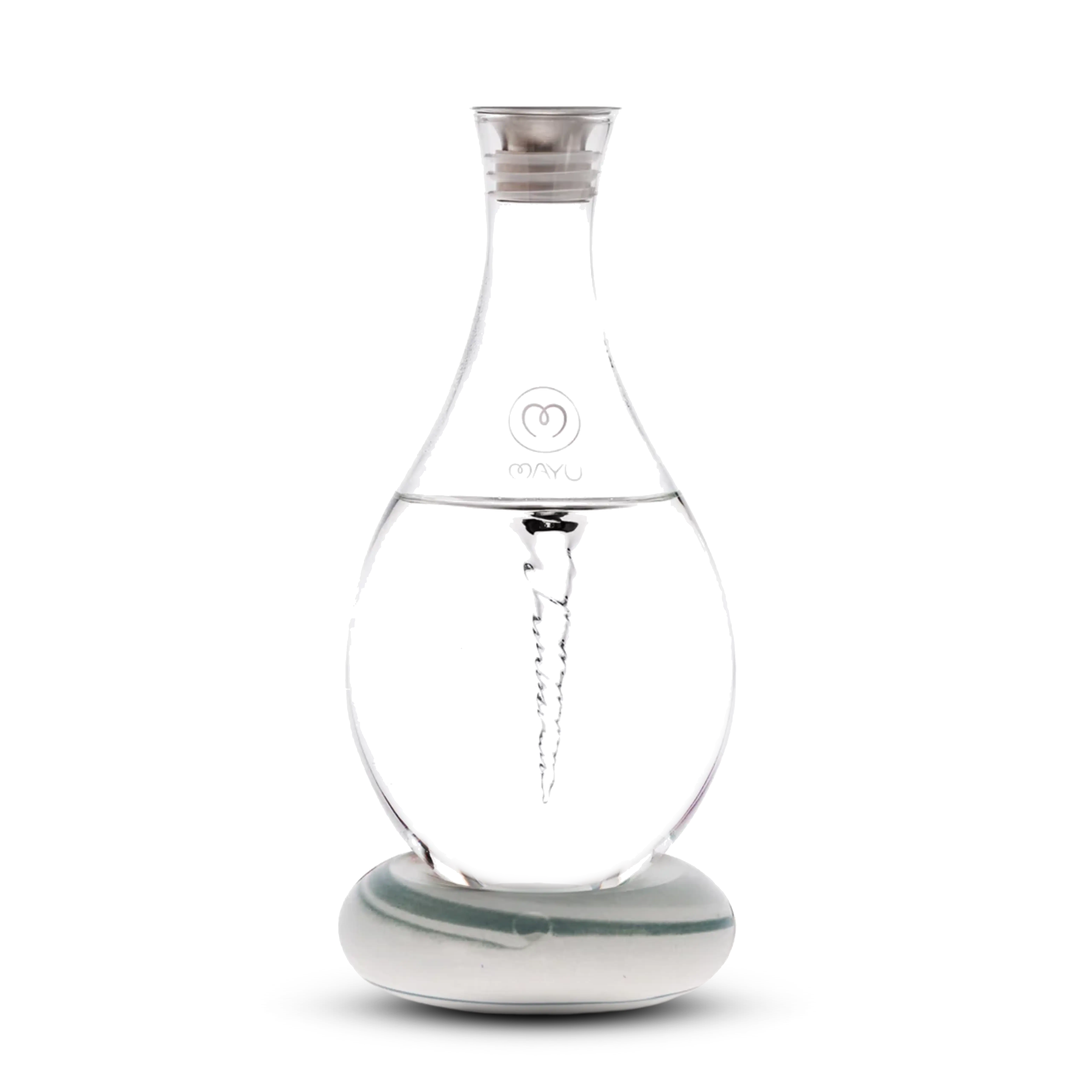 The Mayu Water Swirl Structured Water Carafe, featuring a spiral vortex design inside clear glass, sits on a round white base with a silver cap and branded logo, displayed against a plain white background.