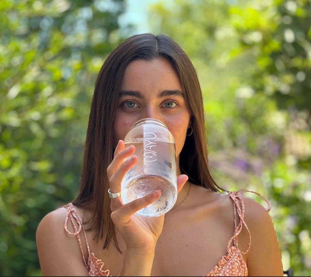 Women drinking out of Mayu water glass bottle 