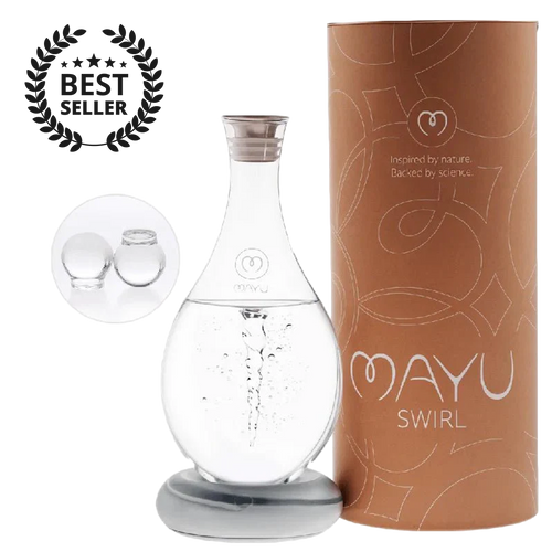 The MAYU Swirl Carafe by Mayu Water, a handblown borosilicate glass carafe on a silver base, sits beside a brown cylinder labeled “MAYU SWIRL.” A “Best Seller” badge and two glass balls highlight this hydration solution.
