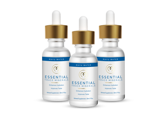 Three bottles of Mayu Water Trace Mineral Drops with gold dropper caps are side by side. The white labels highlight benefits such as enhanced hydration and better taste.