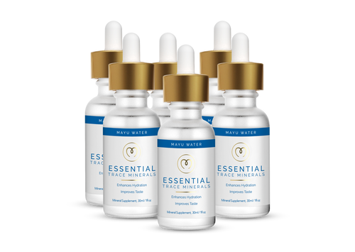 Six bottles of Mayu Water Trace Mineral Drops with gold dropper caps, white labels, and blue accents are displayed in two rows on a white background. The label promotes hydration and taste improvement benefits.