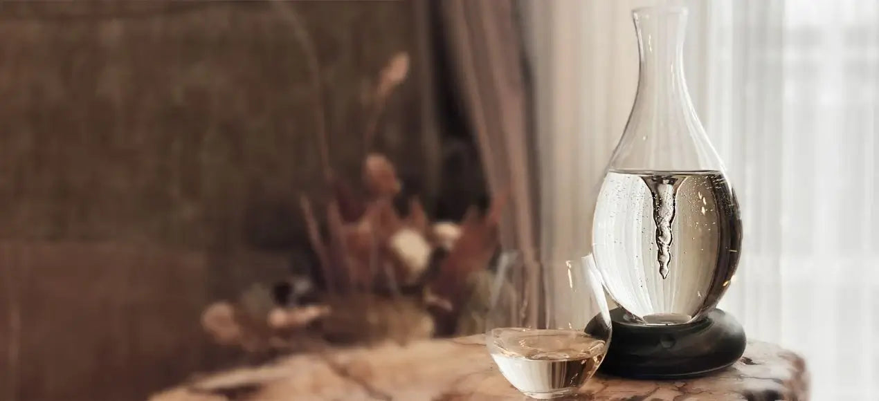 a glass vase sitting on top of a table