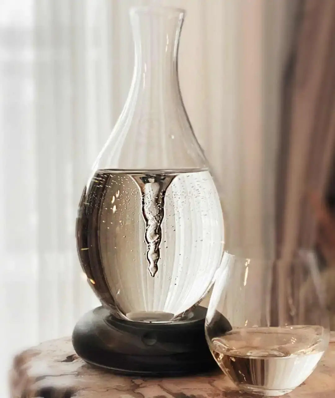 a glass vase sitting on top of a wooden table