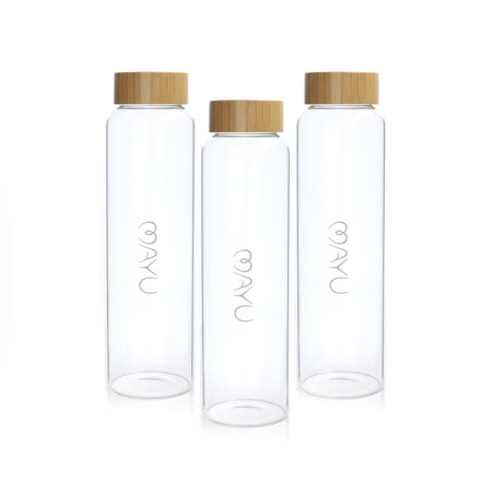 The Mayu Water Pure Glass 1.5L Bottle - Pack of 3 features three upright cylindrical borosilicate glass bottles with bamboo lids, each sustainably made and printed with "natu" vertically on the surface.