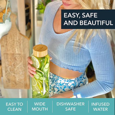 A woman in a blue crop top and floral skirt holds a Mayu Water Pure Glass 1L Bottle, filled with cucumber-infused water. Text highlights: Easy, Safe and Beautiful, Easy to Clean, Wide Mouth, Dishwasher Safe. Pack of 3.
