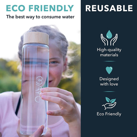 A person holds the Mayu Water Pure Glass 1L Bottle—sold in a pack of 3. This reusable, eco-friendly bottle features high-quality borosilicate glass and a wooden lid, designed with love to be environmentally friendly.
